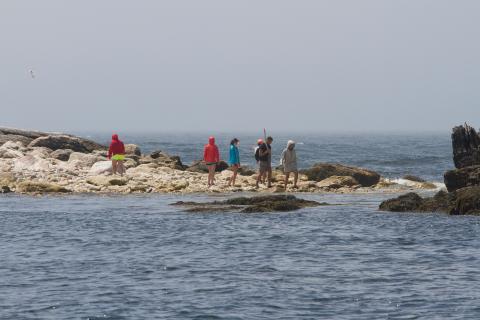 a group of young students outside by the ocean